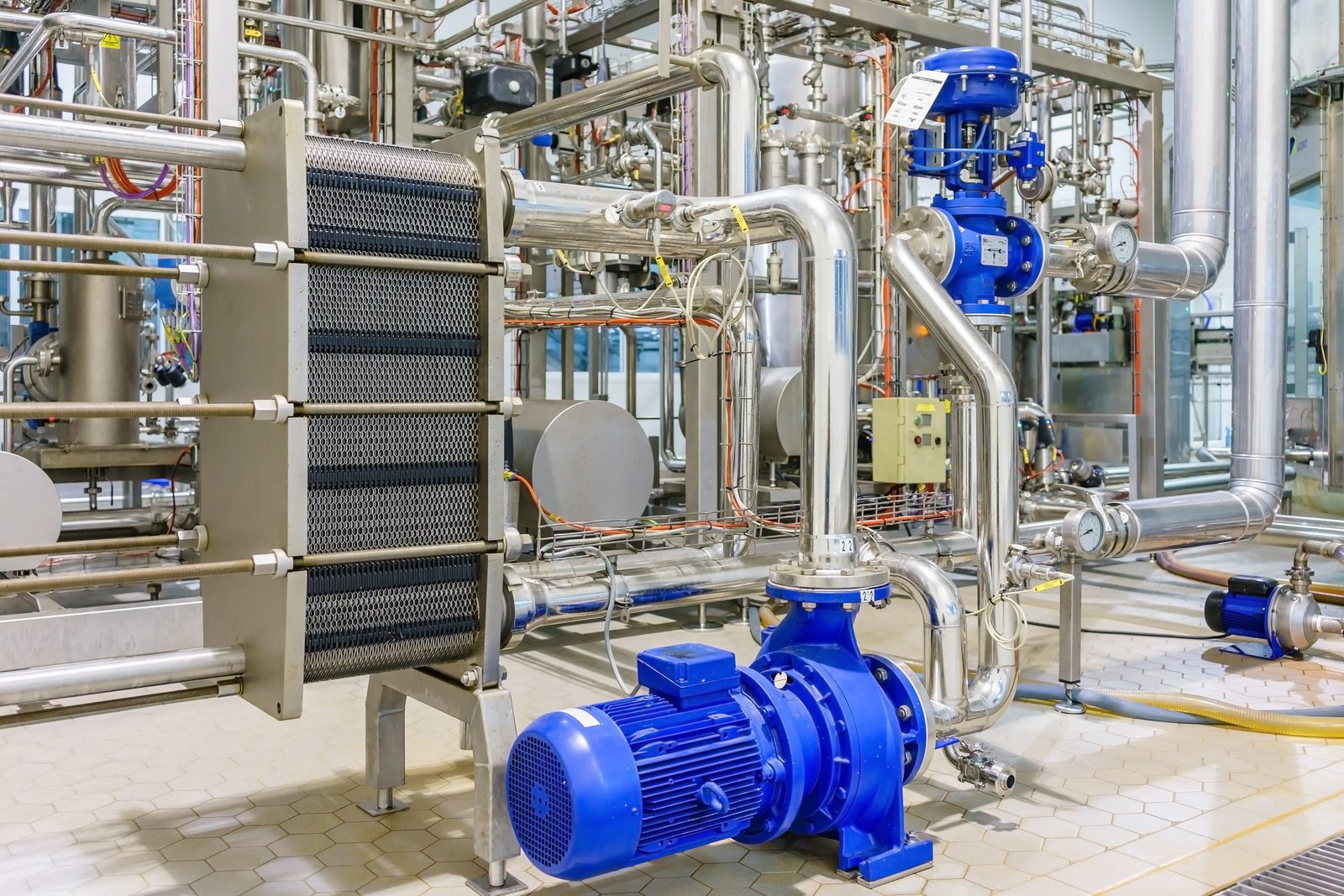 Stainless process piping, heat exchanger, and pumps in a pharmaceutical utility room